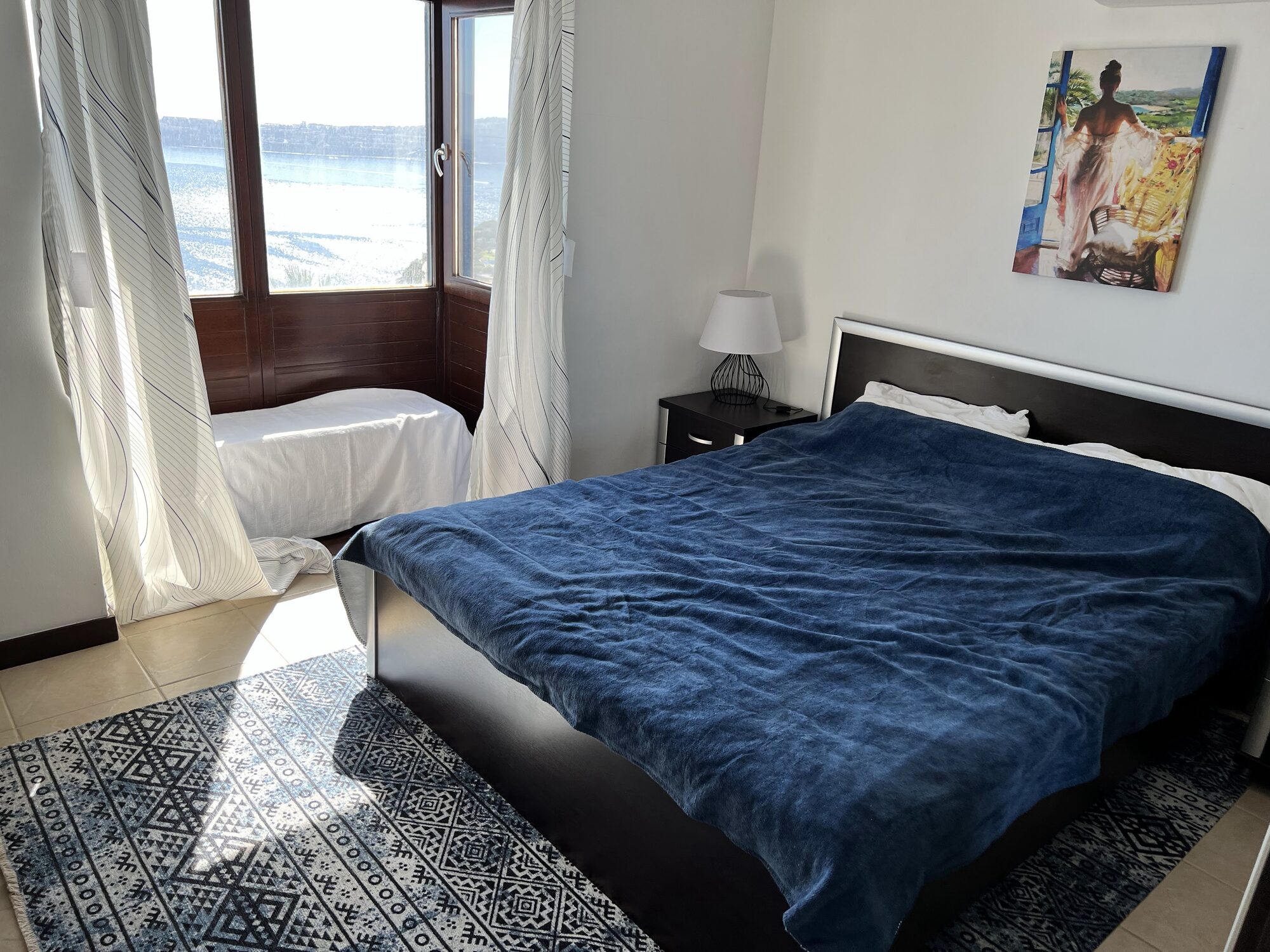 Bedroom with a large window looking out over the sea
